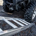 close up view of ATV tires at the ground and starting to climb on the aluminum ramps