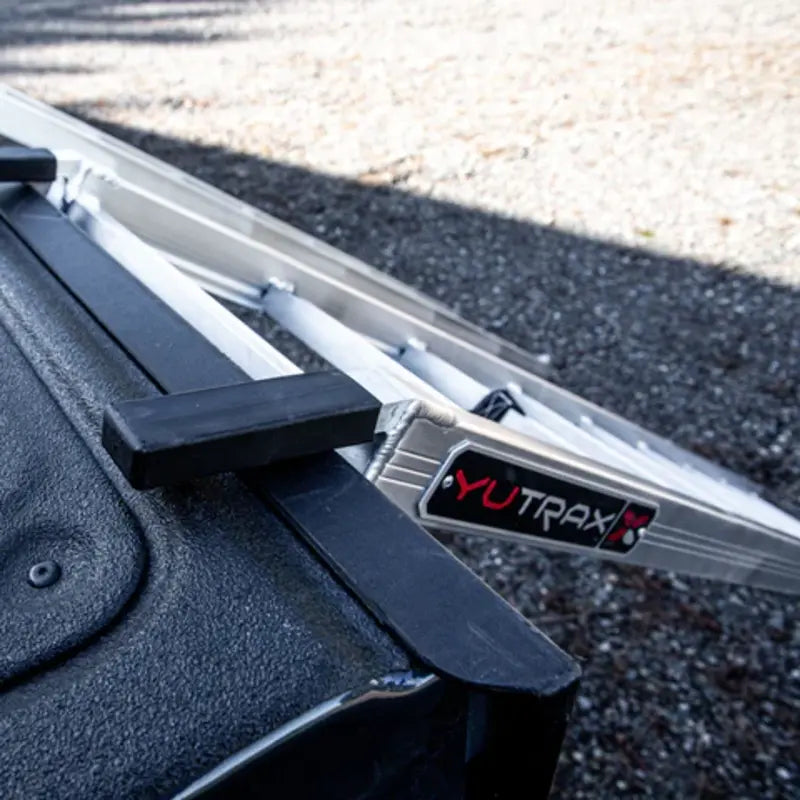 rubber tab that holds the aluminum loading ramp and ATV