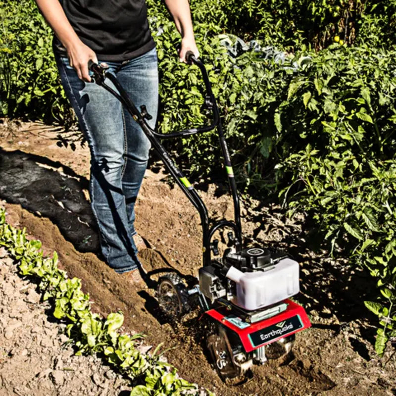 man holding the handle bar  of Earthquake MC33 Cultivator