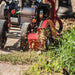 Front View Of a Man Clearing The driveway using Earthquake Walk Behind Edger