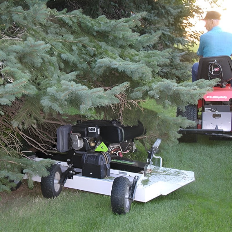 Kunz Engineering AcrEase H40B 40 inch 10.5HP Finish Cut Pull Behind Mower being towed by a lawn tractor beside a tree