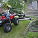 Kunz H40B Finish Cut Mower AcrEase 10.5 HP being towed by woman on atv