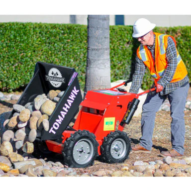 Man Dumping Gravel Using the Tomahawk 30 Inch Concrete Power Buggy Electric Battery Mini Dumper