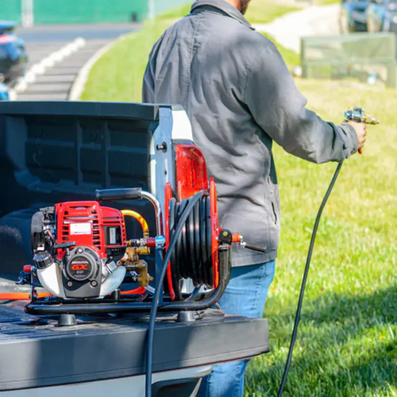 Man Spraying his Yard using the Tomahawk 1.6HP Skid Sprayer Barrel Mount Only with Honda GX35 100ft Hose and 500 PSI Pump for Pest Control