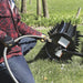 Man filling the Strongway Drum Spike Lawn Aerator 36 Inch 78 Spikes with water