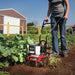 Man operating the Earthquake MC43 Cultivator Tiller Engine Left Side View