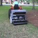 rear view of a tractor with first products UA40 Aera vator and a spike shaft with standard roller attached