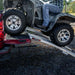 Side view of an ATV climbing on the Yutrax 89" Folding XL Aluminum Arch Ramps