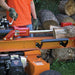 closed up view of a man operating the Brave VH1724GC 24 Ton Log Splitter Powered by Honda GC160 in horizontal position