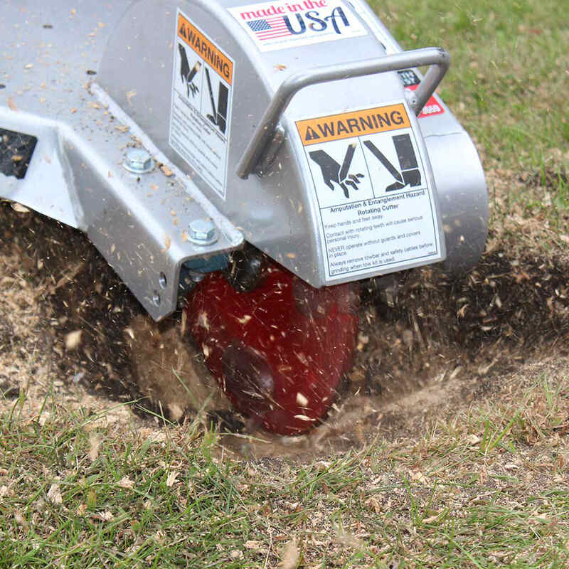 tree chips splashing around from the tree stump with the Dosko Walk Behind Swivel Stump Grinder