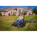 front view  of a man driving his lawn mower with the FCE11544BS