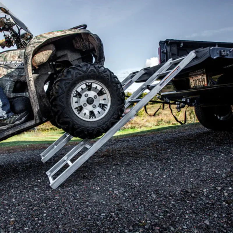 ATV front wheels on the middle of the loading ramps which mounted to ATV