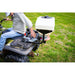 man driving his ATV while adjusting the seeds spreader mounted on it