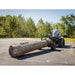 man driving his ATV with a log mounted to Swisher Tow Behind ATV Log Skidder