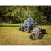 man driving his ATV with Swisher Tow Behind ATV Log Skidder and log