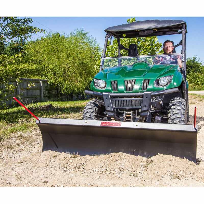 Front view of a man driving a green UTV with Swisher 2850 62" Rolled  Steel UTV Plow  Blade mounted on it
