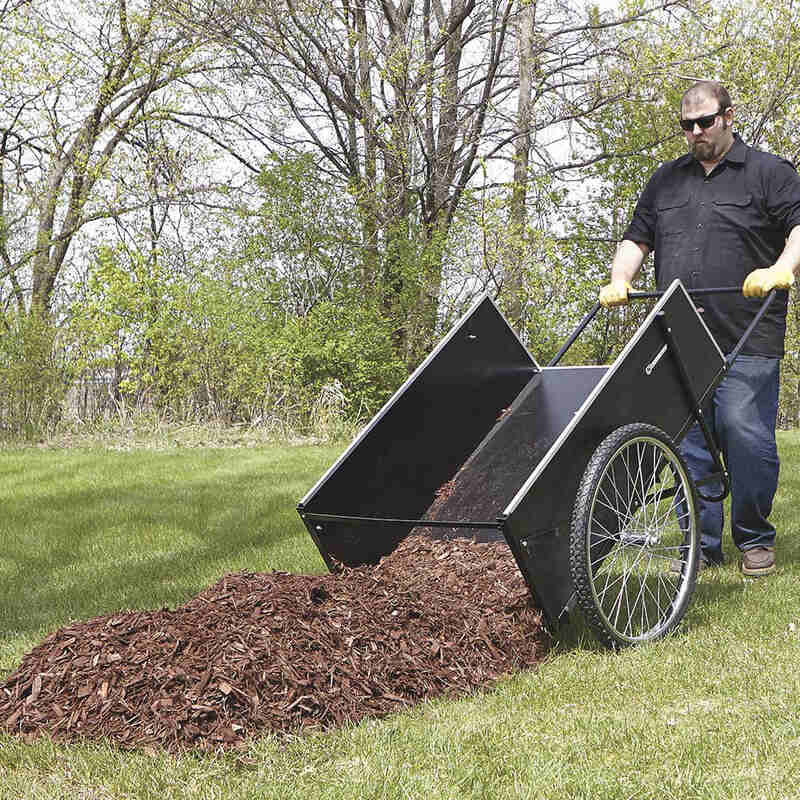 man dumping the rotten tree barks on his lawn from his cart