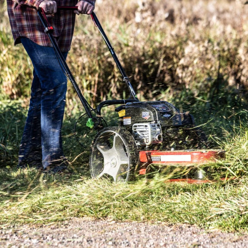 man easily cutting grass with the earthquake String Mower 163cc Briggs