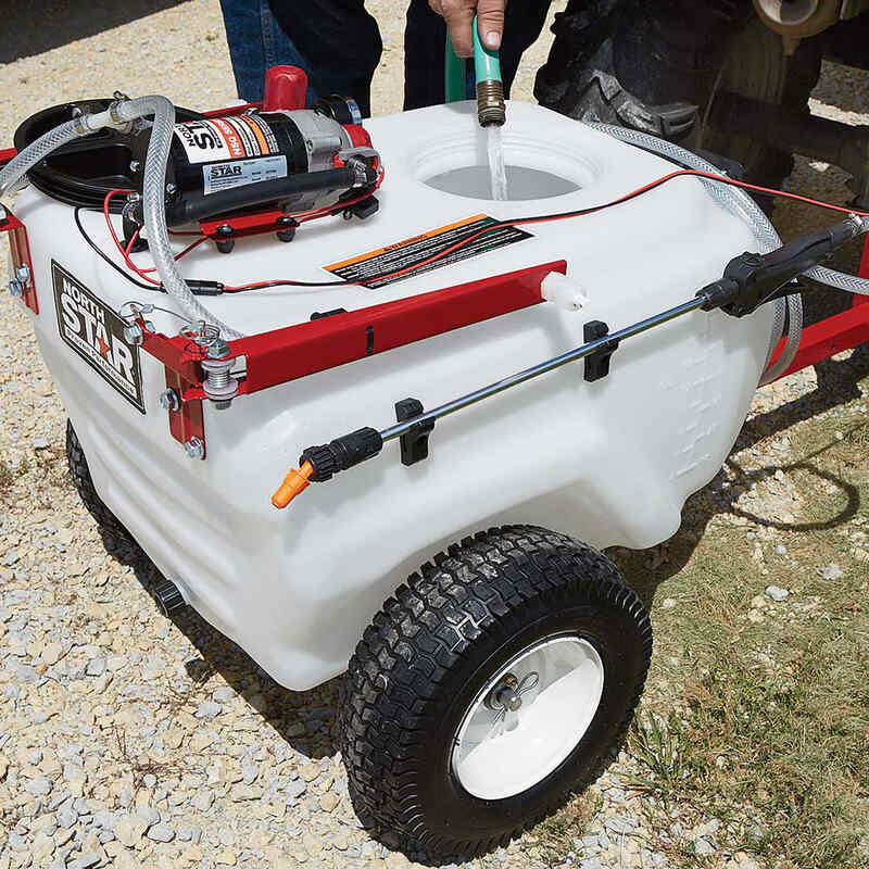 man filling the tank of NorthStar tow-behind broadcast and spot sprayer-21 gallon capacity with water