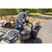 man loading a huge log to his Swisher Tow Behind ATV Log Skidder