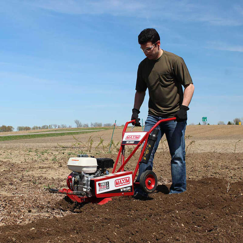 man operating his maxim compact tillers in his wide farm 