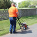 rear view of a man in orange shirt operating the BravePro 10" Lawn Edger Honda GX120 (BRPE105H)