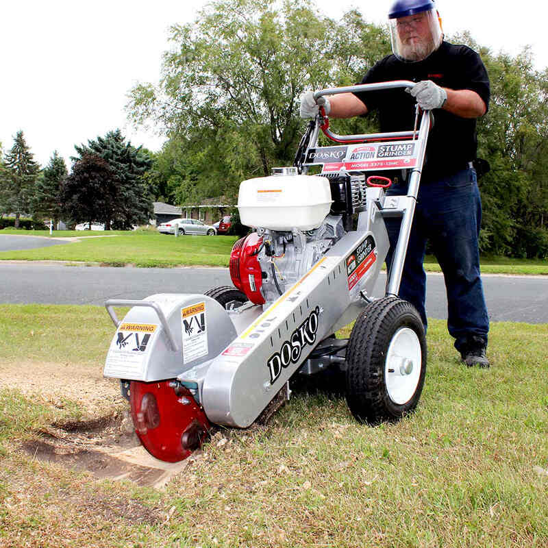 man operating the Dosko Walk Behind Swivel Stump Grinder