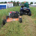 main riding on his ATV with the BravePro 44 Inch Rough Cut Tow Behind Trail Cutter (BRPRC108HE) mounted in offset position