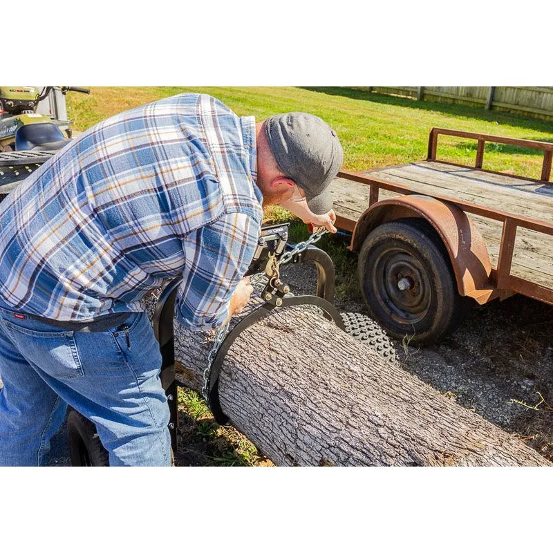 man secure the log with Swisher Tow Behind ATV Log Skidder's lifting tongs