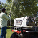 man spraying water on the tree with the NorthStar ATV boomless broadcast and spot sprayer mounted on his ATV