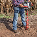 man using Earthquake E43 Auger Powerhead to drill on the ground