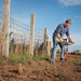 man using the E43 powerhead and included 8 inch auger bit to drill deep into the earth