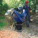 front view of a man feeding a tree branch into his Powerhorse Rotor Wood Chipper 