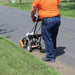 man in orange shirt operating the BravePro 10" Lawn Edger Honda GX120 (BRPE105H)