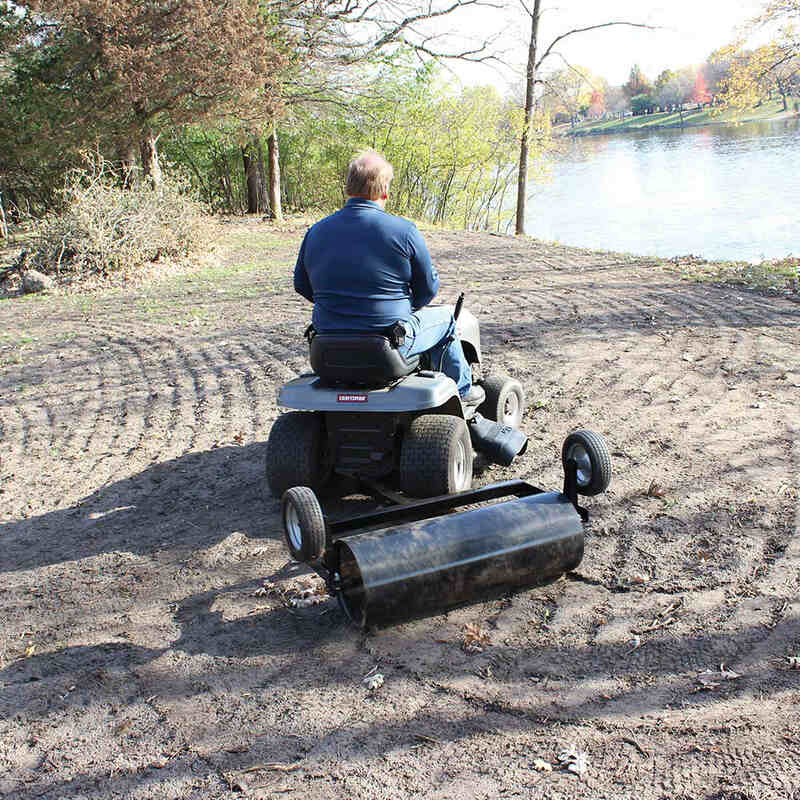 man turning right while riding his lawn mower with maxim 36 Inch mounted on it