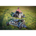 rear view of a man driving his lawn tractor with Swisher FC15560BS