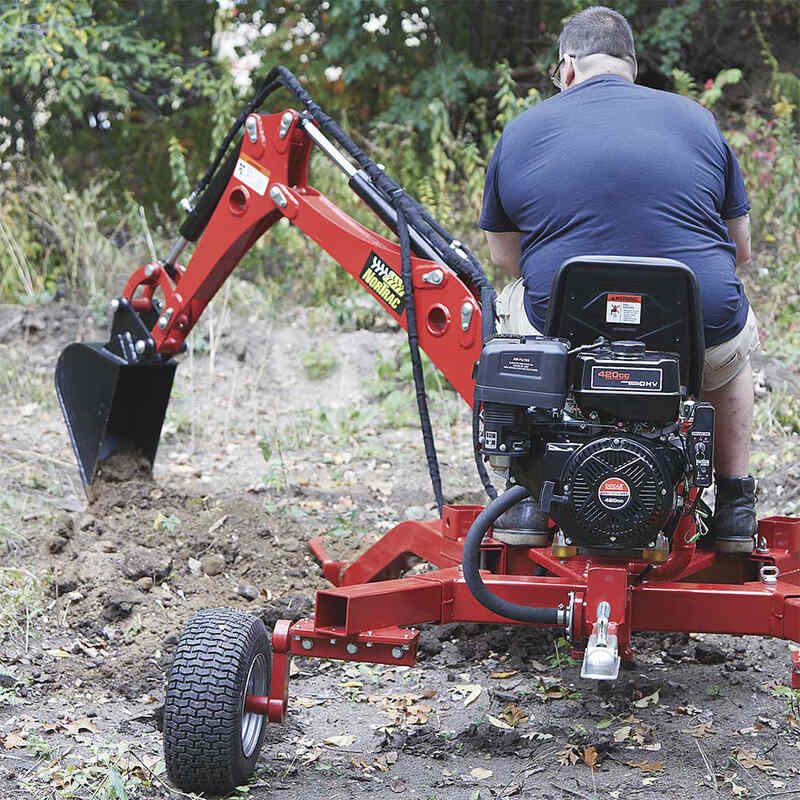 man operating his NorTrac Towable Trencher with NorTrac Trencher 10-in. Bucket Attachment installed