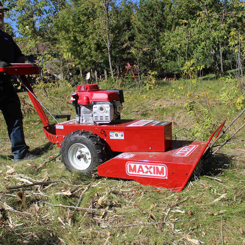 side view of the maxim brush cutter on the grassy field