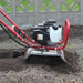 maxim mini max tiller on the garden with its tines covered in soil