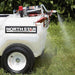 NorthStar tow-behind broadcast and spot sprayer-21 gallon capacity with its 2 nozzle turned on