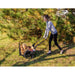 woman pushing her  Firewood Utility Cart  with wheels full of chopped firewoods