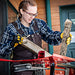 woman splitting wood with the 5-Ton Electric Log Splitter w/ Stand